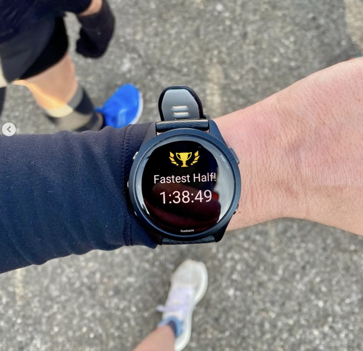 Garmin watch showing a fastest half marathon time of 1:38:49