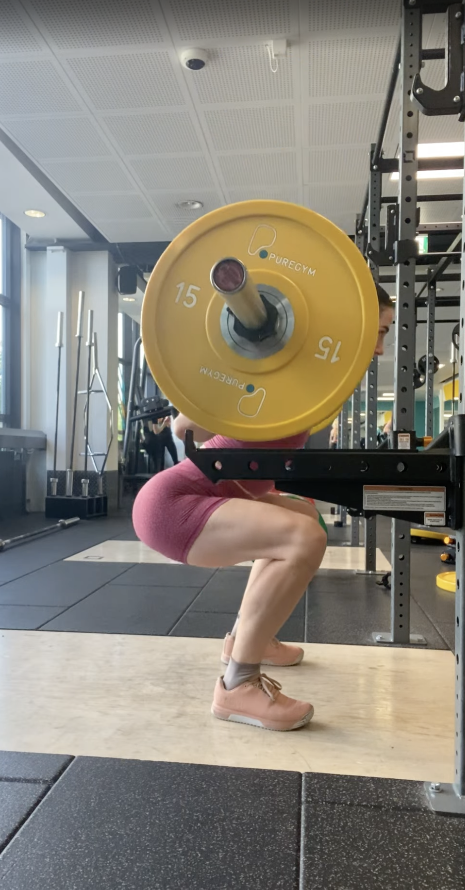 Katelyn squatting with a barbell at PureGym